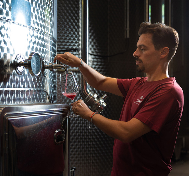 About us | Cesari | Cesari | identity winemaker tasting red wine from stainless steel tank caucasian man with mustaches and goatie